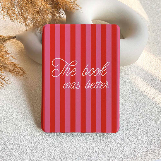 A striped Kindle case in red and pink with the phrase 'The book was better' written on the front.