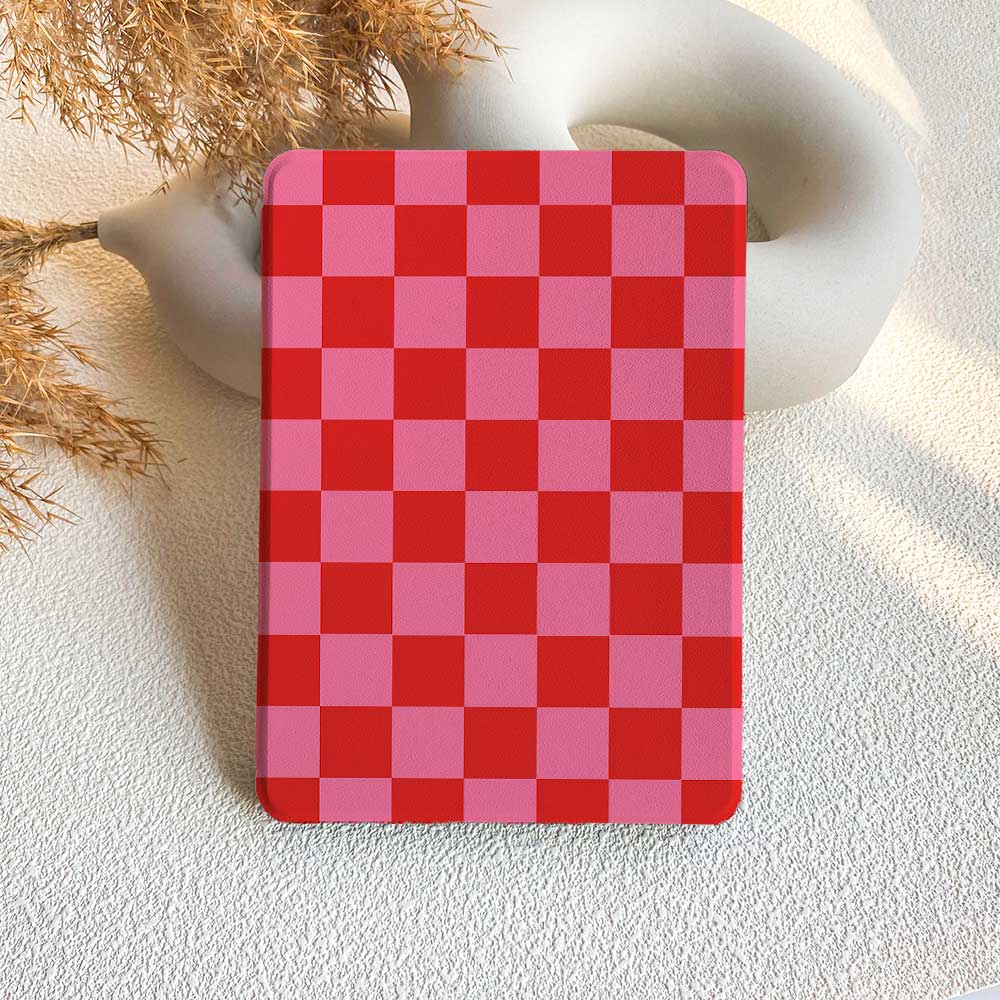 A checkered pattern Kindle case in red and pink, displayed on a white surface.