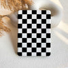 A Kindle case with a black and white checkerboard pattern displayed on a neutral background.