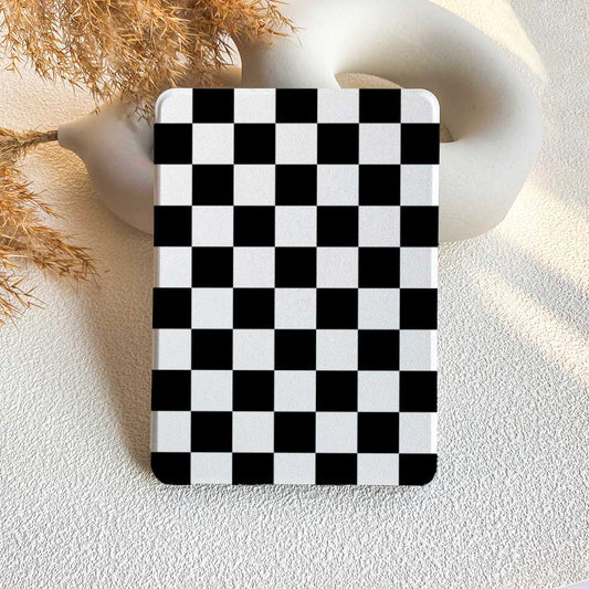 A Kindle case with a black and white checkerboard pattern displayed on a neutral background.