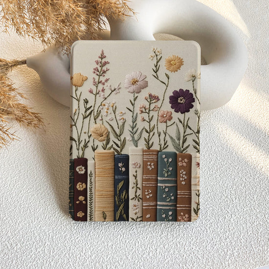 Decorative coaster with floral and book design on a textured surface