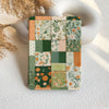 Patchwork notebook with floral patterns on a textured surface