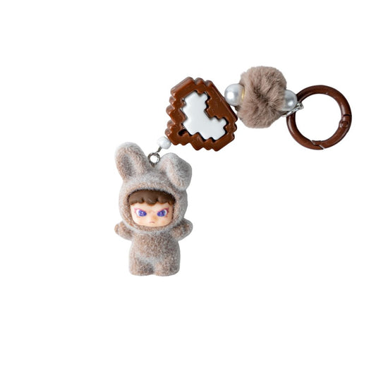 Plush toy keychain with a small figure in a hooded outfit on a white background