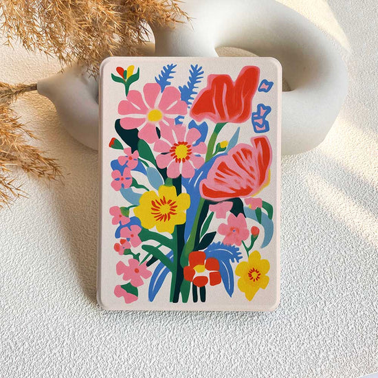 A Kindle case featuring a colorful floral pattern with prominent pink and red flowers.