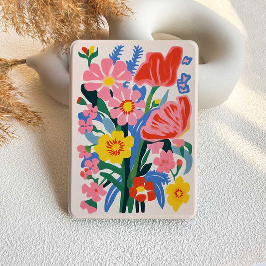 A Kindle case featuring a colorful floral pattern with prominent pink and red flowers.