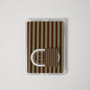 A clear plastic sleeve containing a small rectangular card with vertical olive green and dark red stripes, featuring a white U-shaped clip or hook on the front, photographed on a light gray background.