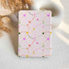 Notebook with colorful heart pattern on a light surface