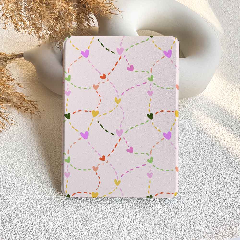 Notebook with colorful heart pattern on a light surface