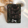 Decorative bookshelf design with flowers and a candle on a textured surface, featuring the name 'Lucy'.
