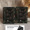 Two Kindle cases with bookshelf design on a textured surface