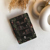 Coaster with bookshelf design featuring books and a skull on a textured surface.