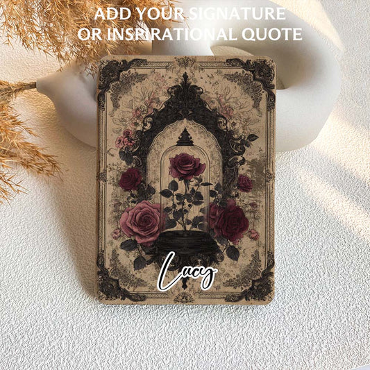 Decorative card with floral design and 'Lucy' signature on a textured surface.