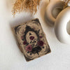 Decorative book with floral design on a textured surface