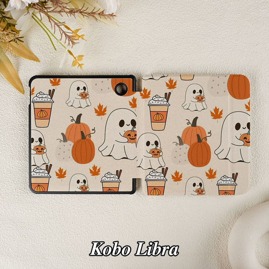 Kobo Libra e-reader with a Halloween-themed case on a textured surface.