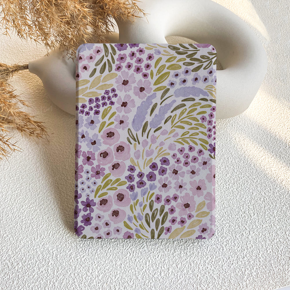 Floral patterned notebook on a textured surface with decorative elements