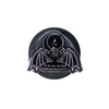 Black and white decorative item with bat wings and celestial design on a light gray background