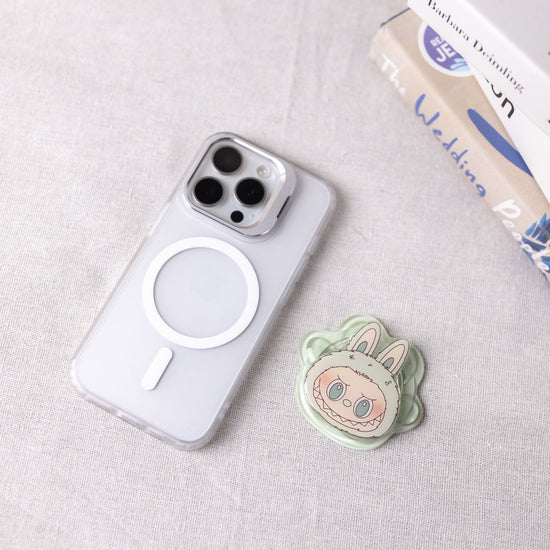 Phone case with a cute animal design on a light gray surface
