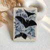 Notebook with bat and leaf design on a textured surface