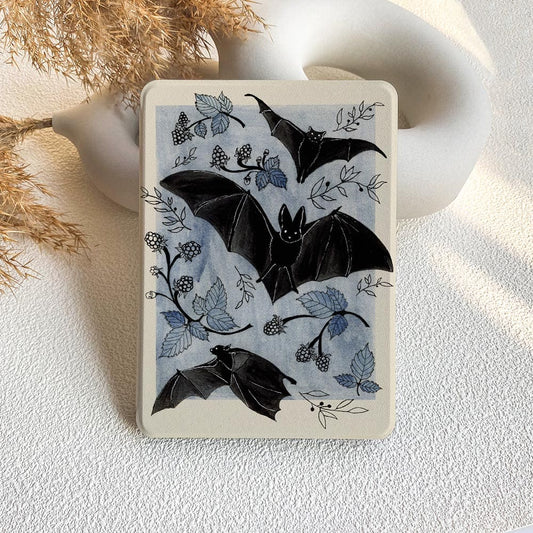 Notebook with bat and leaf design on a textured surface