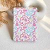 Notebook with pink octopus pattern on a textured surface
