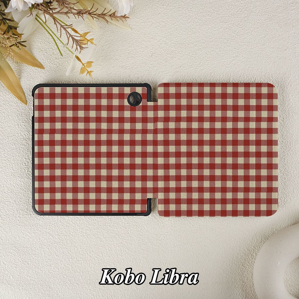 Red and white checkered case for Kobo Libra on a textured surface with flowers.