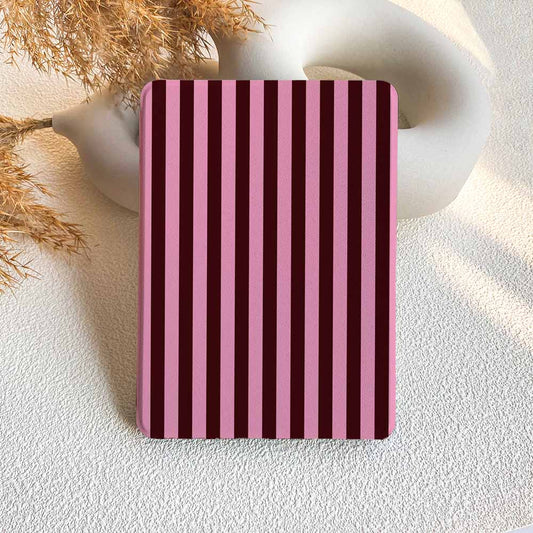 Rectangular object with pink and purple vertical stripes on a textured surface.
