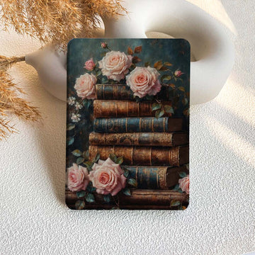 kindle case  with vintage books and roses design on a textured surface.