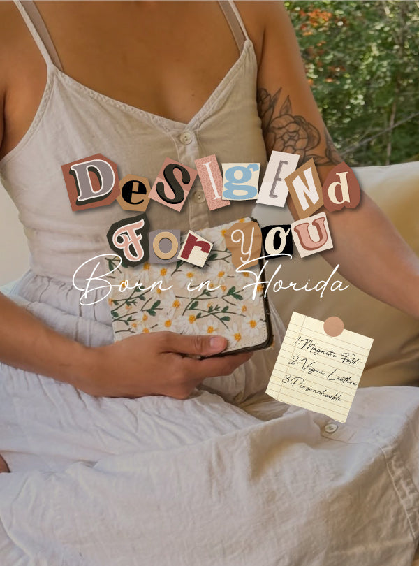 Person holding a book with decorative letters spelling 'Design for you Born in Florida' against a natural background.